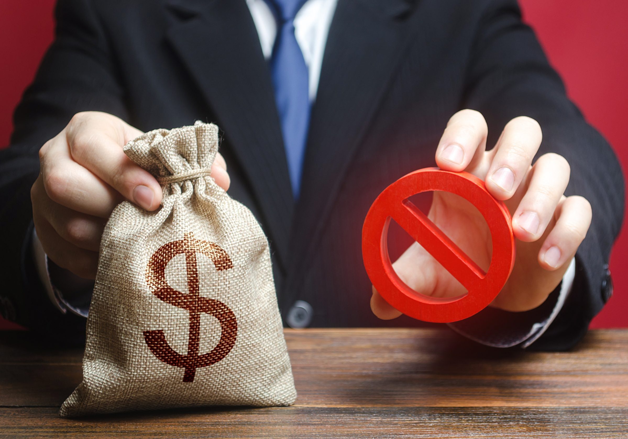 Businessman refuses to give a money bag. Denial of cooperation. Refusal to grant loan mortgage, bad credit history. Economic sanctions, confiscation funds, deductions and fines. Financial difficulties