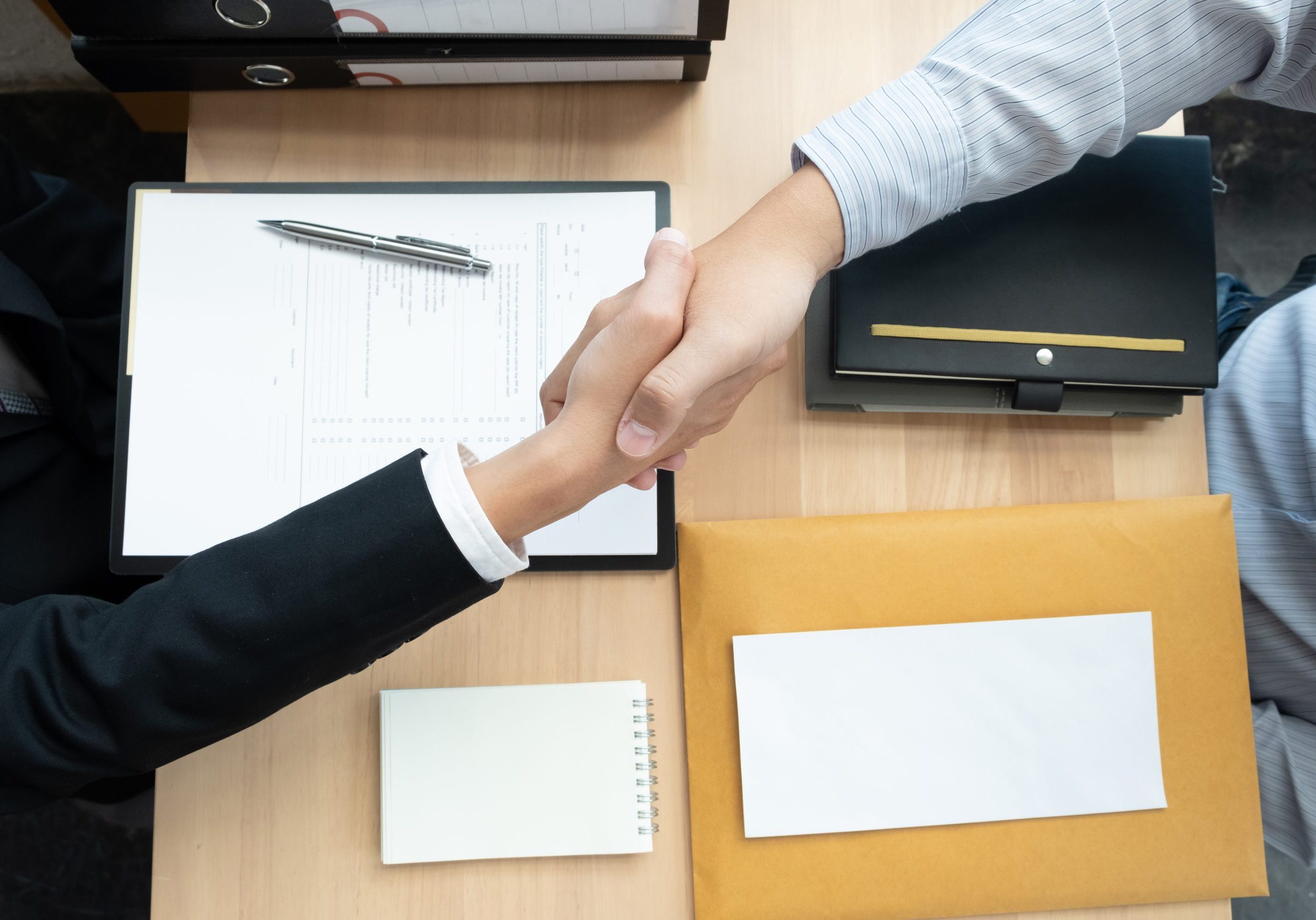 Businessmen making handshake in the office room. business etiquette, congratulation, greeting, and dealing.
